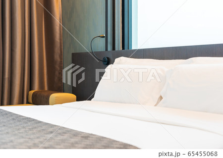 Beautiful luxury comfortable white pillow and blanket on bed with light lamp 65455068