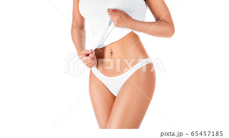Slim tanned woman's body. Woman showing her waist. Isolated over white background. 65457185