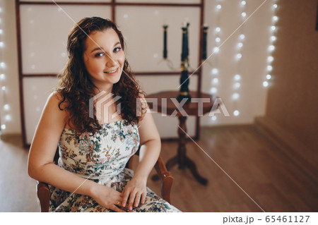 the girl is sitting on the chairs. spending time in self-isolation. interior decoration 65461127