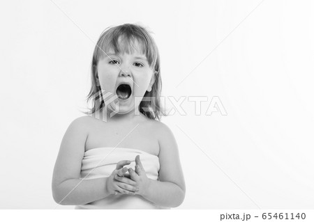 little girl with their mouths wide open on a white background. The child are playing. the concept of education , childhood, emotions, dentistry, surprise, friendship. Copy space 65461140