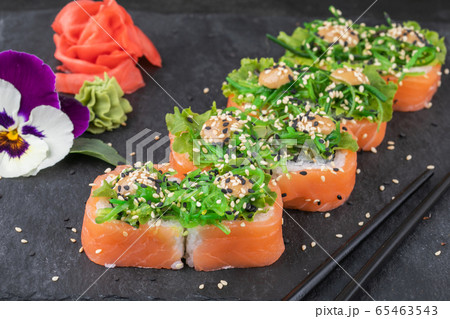 Sushi rolls with seafood and Chuka salad. Green sushi. Top view. Free space for your text. 65463543