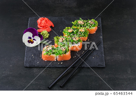 Sushi rolls with seafood and Chuka salad. Green sushi. Top view. Free space for your text. Sushi rolls with seafood and Chuka salad. Green sushi. Top view. Free space for your text. 65463544