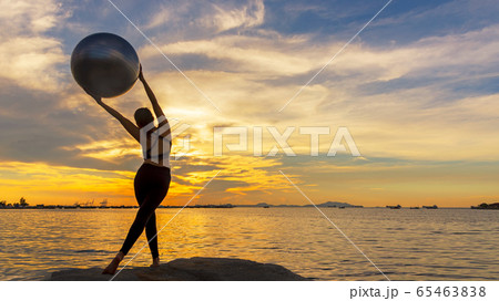 Lifestyle woman yoga and gym ball exercise and pose for healthy life.  65463838