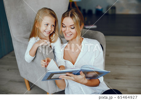Mother reading a book with daughter Mother reading a book with daughter 65464927