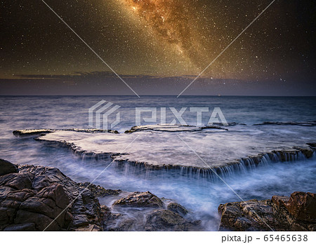 Waterfall in sea and milky way 65465638