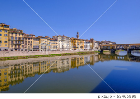 The famous Ponte Vecchio, the Old Bridge and city houses with reflections in the Arno River, Florence, Tuscany, Italy 65465999