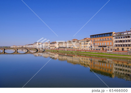 The famous Ponte Vecchio, the Old Bridge and city houses with reflections in the Arno River, Florence, Tuscany, Italy 65466000