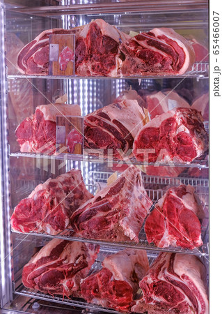 Raw dry aged Bistecca Alla Fiorentina, T-Bone or Porterhouse Steak at the entrance of a restaurant in Florence, Italy 65466007