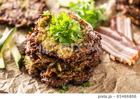 Crunchy zucchini pancakes with bacon parsley herbs Crunchy zucchini pancakes with bacon parsley herbs 65466806