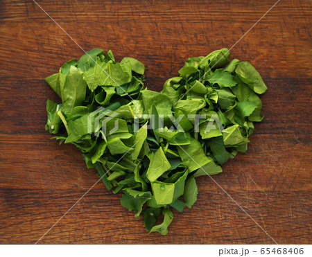 chopped spinach in the form of a heart on a cutting board chopped spinach in the form of a heart on a cutting board 65468406