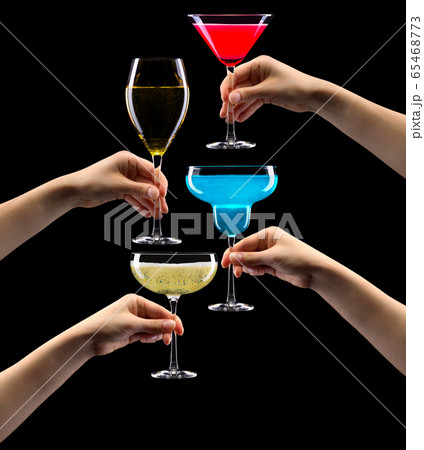 Set of hands holding cocktails isolated on black background Set of hands holding cocktails isolated on black background 65468773