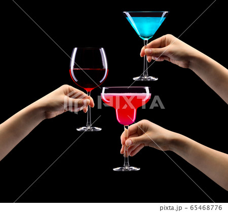 Set of hands holding cocktails isolated on black background Set of hands holding cocktails isolated on black background 65468776