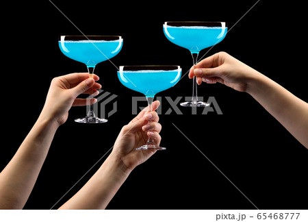 Set of hands holding glass of blue sparkling champagne isolated on black. Set of hands holding glass of blue sparkling champagne isolated on black. 65468777