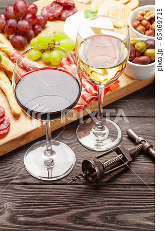 Cheese, meat, grapes and olives antipasto and wine Cheese, meat, grapes and olives antipasto and wine 65469713