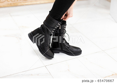 Female legs in fashionable leather black boots 65470667