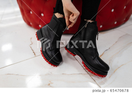 Fashionable woman sits in a store and measures Fashionable woman sits in a store and measures 65470678