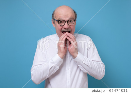 Amazed afraid senior man is shocked with news Amazed afraid senior man is shocked with news 65474331