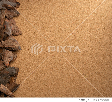 Line of Pine Tree Bark Chip on Brown Cork Board Line of Pine Tree Bark Chip on Brown Cork Board 65479906