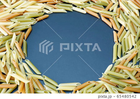 Colored penne pasta close up background with free 65480542