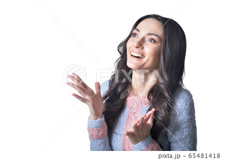 Portrait of beautiful brunette young woman against white 65481418