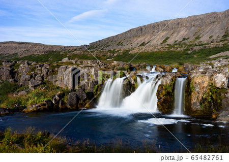 Iceland waterfall closeup view of the gods cliff with long exposure smooth motion of water in summer landscape Iceland waterfall closeup view of the gods cliff with long exposure smooth motion of water in summer landscape 65482761