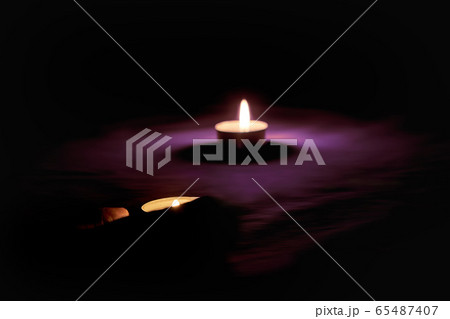 A candle is lit in memory of the victims. 65487407