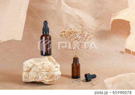 Serum or essential oil in brown glass bottle with Serum or essential oil in brown glass bottle with 65490078