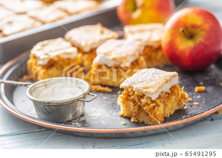 Applie pie cut to cubes with a fresh apple on a Applie pie cut to cubes with a fresh apple on a 65491295