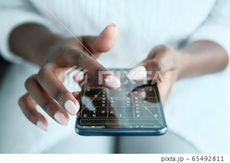 Black Woman Playing Sudoku On Phone For Brain Training 65492811