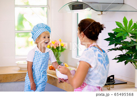 Mother and child cook. Mom and kid cook in kitchen 65495568