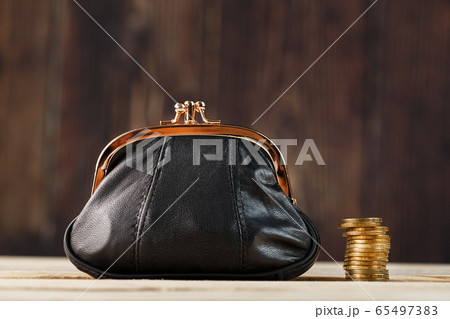 Purse with money and on a wooden table. Budget for Purse with money and on a wooden table. Budget for 65497383