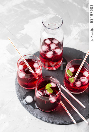 Red alcoholic coctail with ice and mint Red alcoholic coctail with ice and mint 65497603