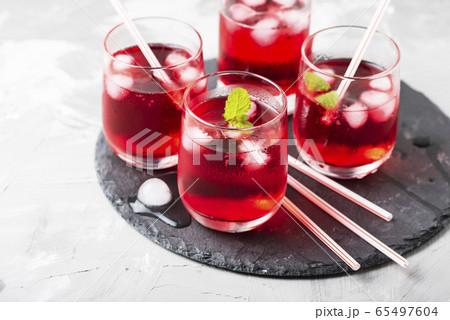 Red alcoholic coctail with ice and mint Red alcoholic coctail with ice and mint 65497604