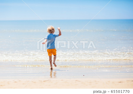 Kids playing on beach. Children play at sea. Kids playing on beach. Children play at sea. 65501770