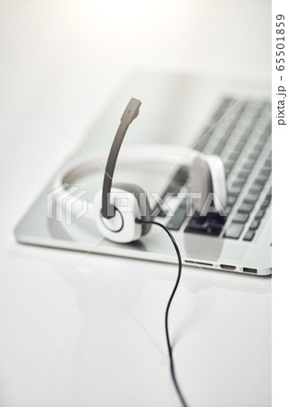 Top view of laptop, headphones with microphone on table . Top view of laptop, headphones with microphone on table . 65501859