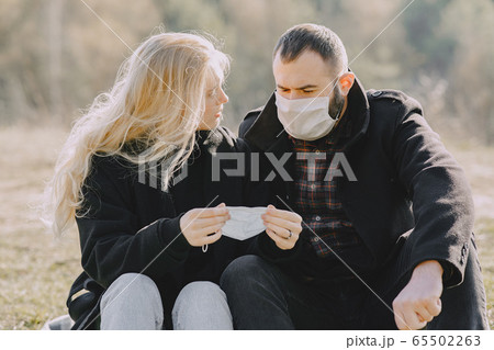 People in a masks walks in a spring forest 65502263