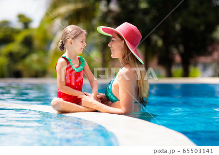 Mother, child at swimming pool. Mom and kid swim. Mother, child at swimming pool. Mom and kid swim. 65503141