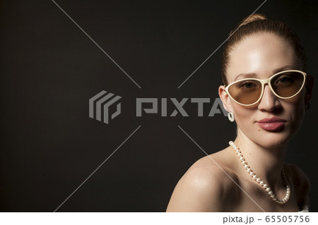 Portrait of Beautiful young woman in sunglasses on 65505756