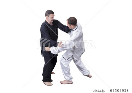 Adult athlete performs formal goju-ryu exercises. 65505933