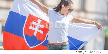 Beautiful young woman holds a flag of Slovakia Beautiful young woman holds a flag of Slovakia 65508769
