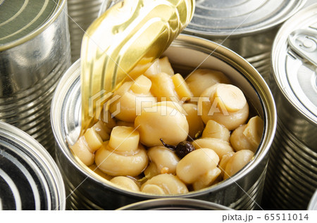 Canned button mushrooms in just opened tin can. 65511014
