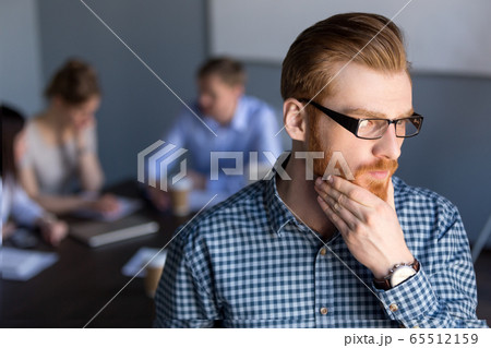 Thoughtful businessman looking away holding hand on chin plannin 65512159