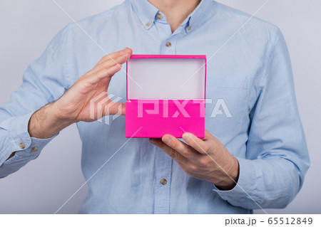 Download Open pink box in the men's hands. Front view. Copyの写真素材 ... Yellowimages Mockups