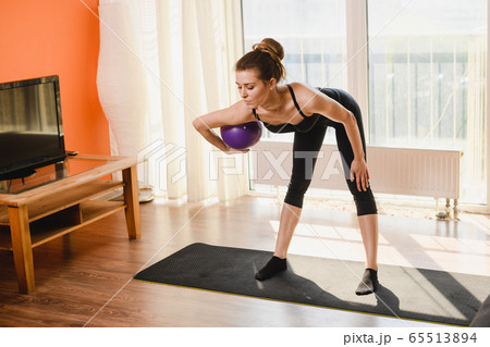 Sport woman training at home with ball 65513894