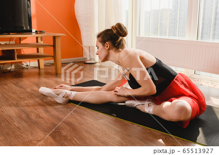 Ballet girl stretch legs at sport mat Ballet girl stretch legs at sport mat 65513927