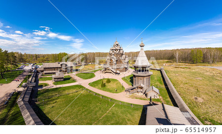 Beautiful Aerial view to traditional Russian village with orthodox wooden chapel and bell tower in Bogoslovka manor. Pokrovskaya multi domed church holy virgin in Easter day. St. Petersburg, Russia. Beautiful Aerial view to traditional Russian village with orthodox wooden chapel and bell tower in Bogoslovka manor. Pokrovskaya multi domed church holy virgin in Easter day. St. Petersburg, Russia. 65514957