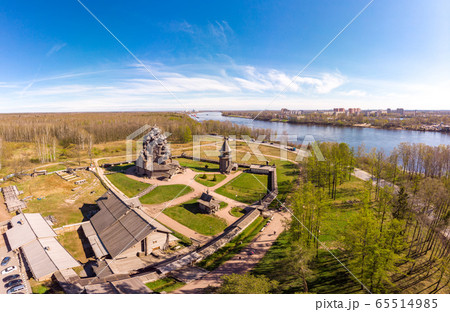 Beautiful Aerial view to traditional Russian village with orthodox wooden chapel and bell tower in Bogoslovka manor. Pokrovskaya multi domed church holy virgin in Easter day. St. Petersburg, Russia. Beautiful Aerial view to traditional Russian village with orthodox wooden chapel and bell tower in Bogoslovka manor. Pokrovskaya multi domed church holy virgin in Easter day. St. Petersburg, Russia. 65514985