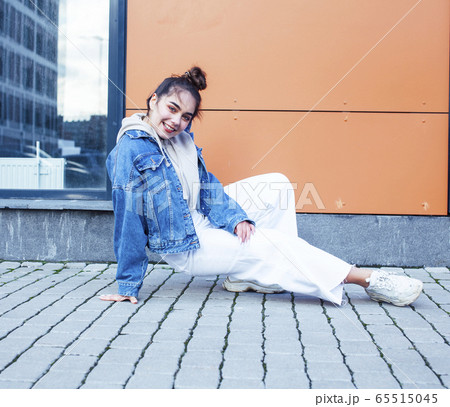 young pretty teenage girl posing cheerful happy smiling wearing street style outside in europe city, lifestyle people concept 65515045