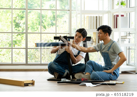 Two carpenters discussed the type of bench being assembled. 65518219