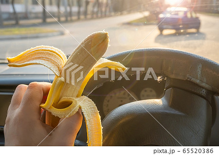food, banana in the hand of the driver 65520386